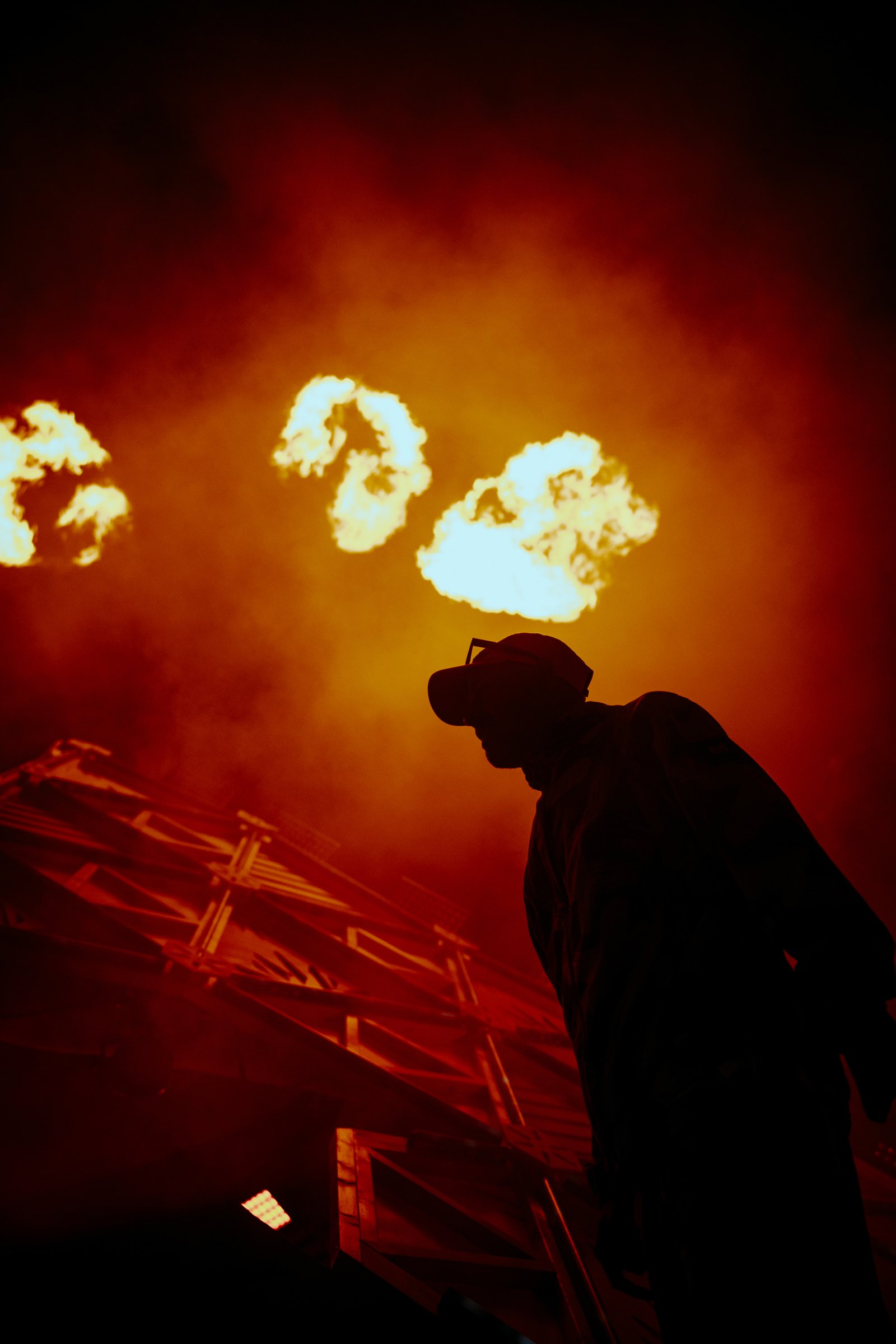 Flames over a truss stage on a beach at night in Thailand