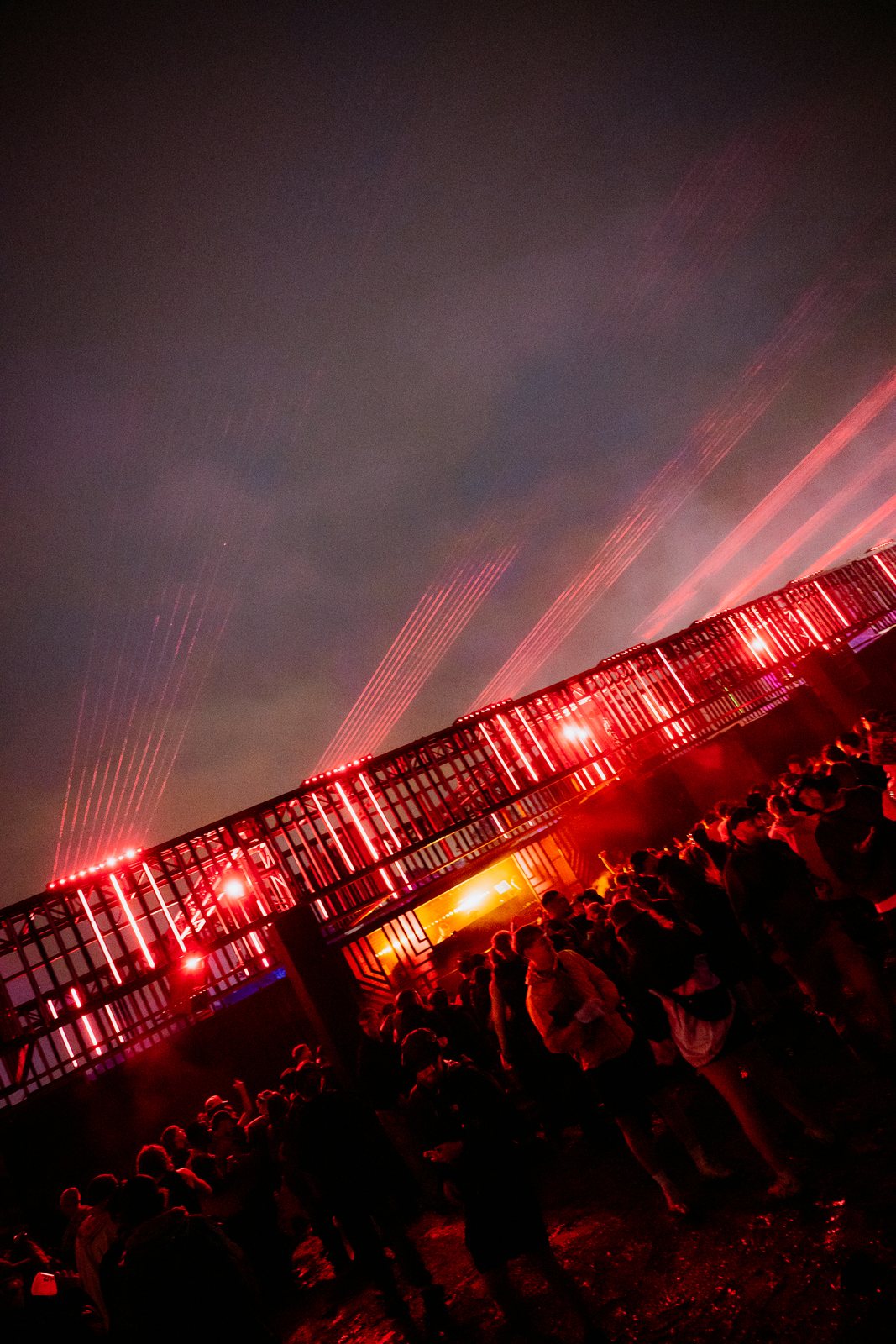 Scaffold stage structure lit red with lasers at night