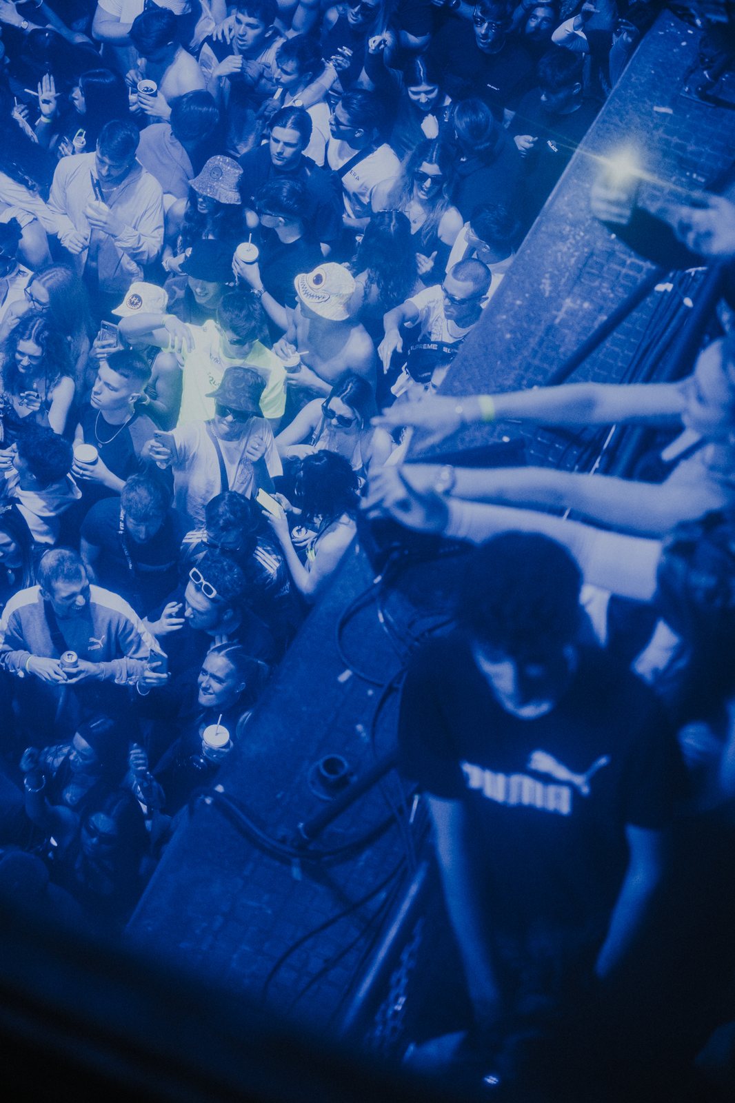 Crowd seen from above under blue light inside a London venue
